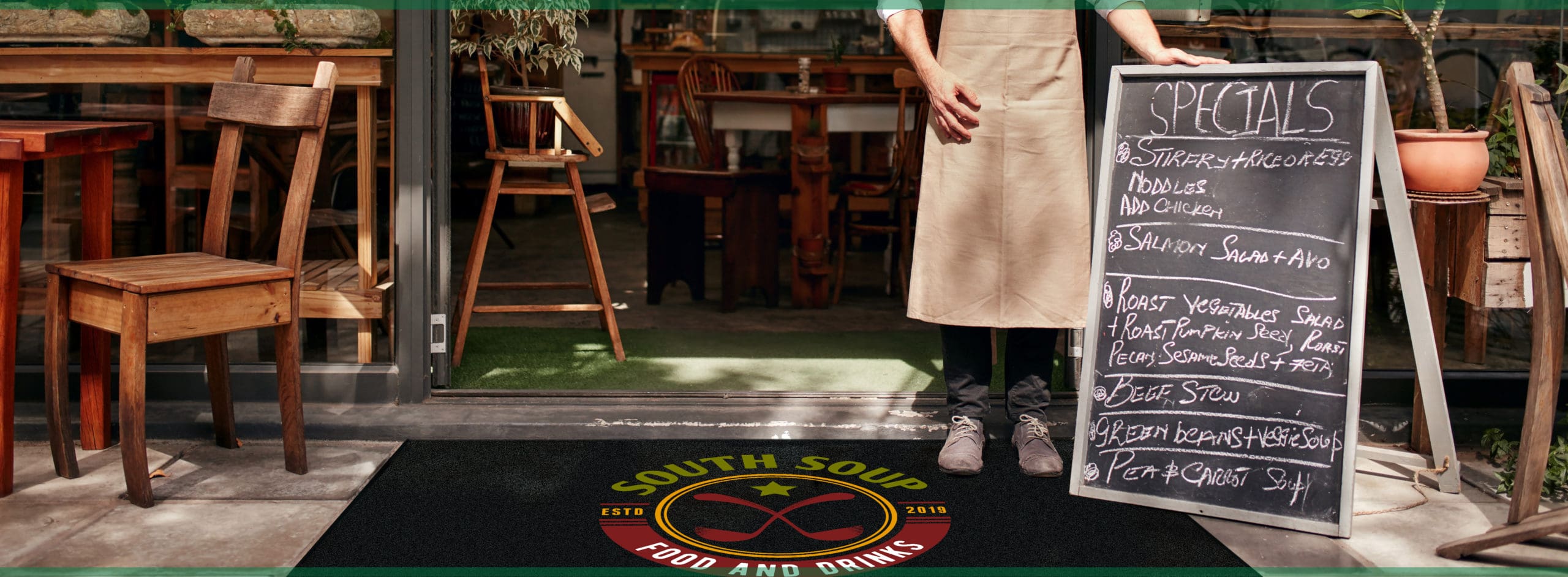 Barista standing in the doorway of a restaurant